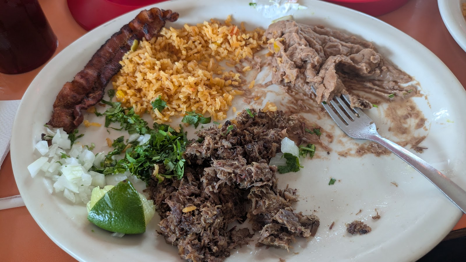 Combo plate with barbacoa, rice, beans, and bacon