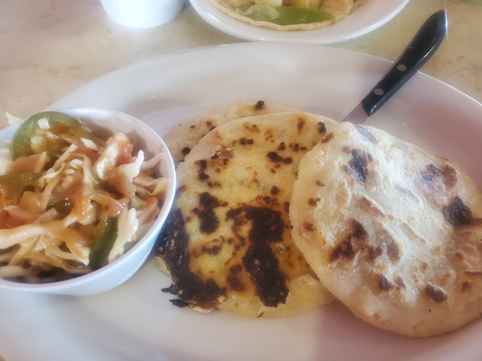 Pupusas served with a side of cabbage slaw